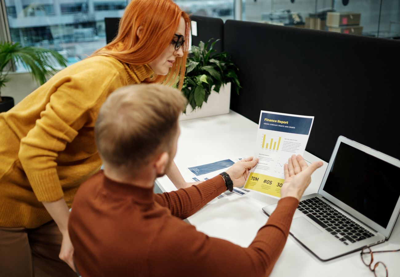 Colleagues reviewing a report together at a desk